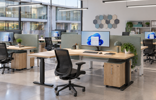 Lifestyle image of Buronomic Alto sit-stand desks with left return and pedestal in an open office