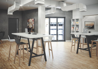 Buronomic Cohesion high coworking tables in black and white in an office space