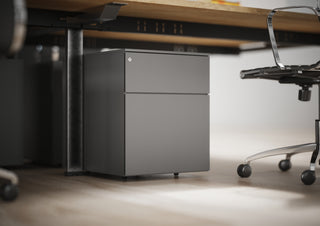 Lifestyle image of Buronomic Paisible metal pedestals in anthracite under a wooden desk